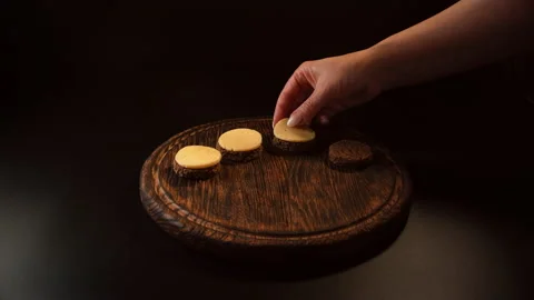 Putting pieces of cheese on bread, making canapes Stock Footage 148625647