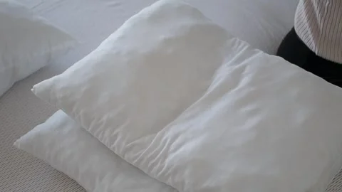 Putting pillows on the bed in a home setting Video stock 344355361