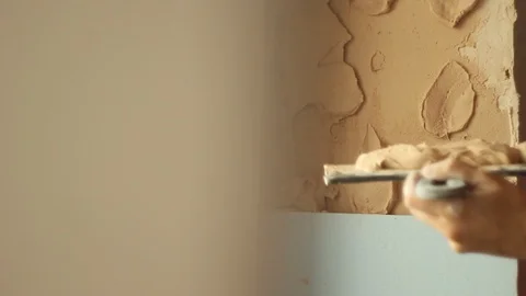 Putting plaster on a wall. building wall finish. apartment renovation Stock Footage 106356141
