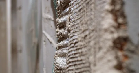 Putting a plastering net into the plaster on the wall, renovation, 4k Stock Footage 129321686
