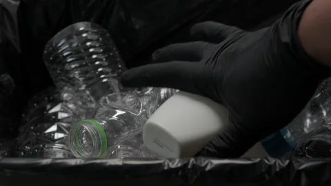 Putting Plastic Bottle  And Shampoo Bottle In Garbage Video stock 103985228
