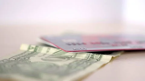 Putting Plastic Cards On Top Of Dollar Bill Stock Footage 164147091
