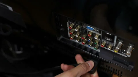 Putting plugs into television Stock Footage 62279970