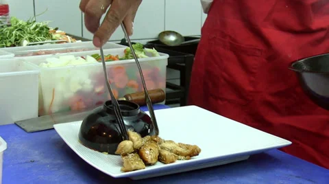 Putting portion of meal on a plate. 2 shots Stock Footage 32690576