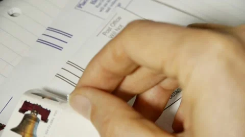 Putting post stamp on envelope 스톡 동영상 10797718