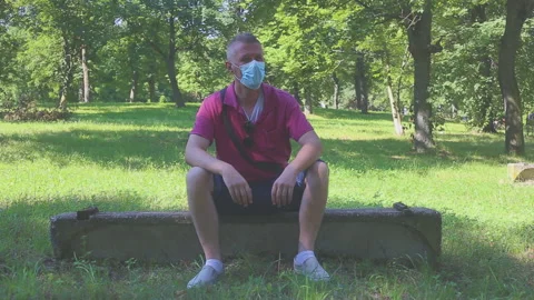 Putting protective mask on face Stock Footage 159995584