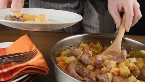 Putting quail stew on a plate Stock Footage 72193352