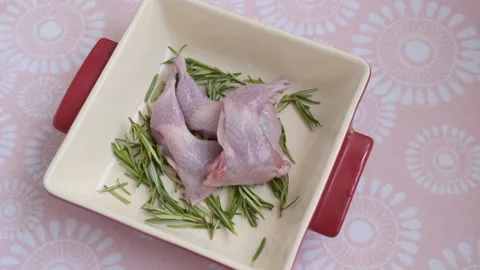 Putting quails legs in a baking dish Stock-Footage 270594281