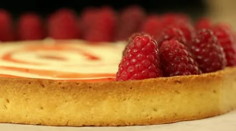 Putting raspberries on tart Stock Footage 11370426
