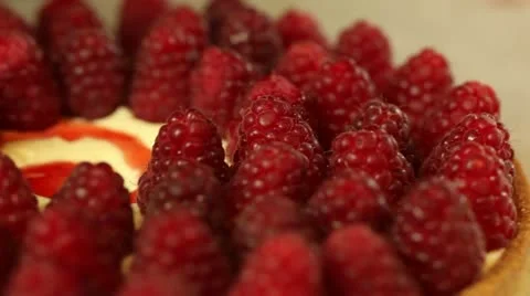 Putting raspberry on tart Stock Footage 11370504