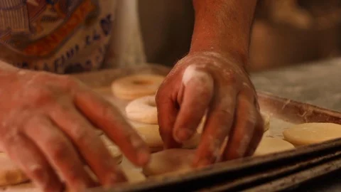 Putting raw donuts to fry Stock Footage 130086980