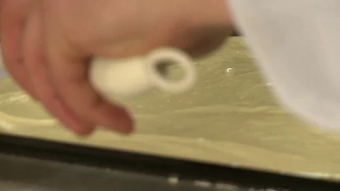Putting ready dessert dough on a pan for baking Stock Footage 72090085