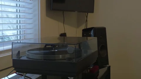 Putting a record on turntable. Snowing outside. Stock Footage 106026223