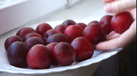 Putting Red Plums On The Plate Video stock 65774206