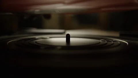 Putting a red vinyl record on turntable and playing it Stock Footage 129572849