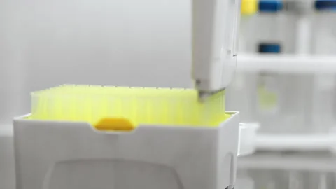 Putting a replacement pipette tip onto a multi-channel automatic pipette. Stock Footage 294158278