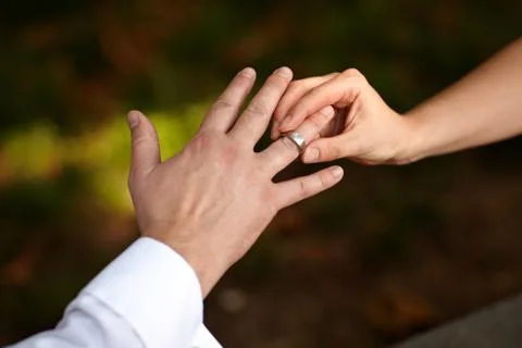 Putting ring on finger Stock Photos