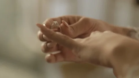 Putting on ring hands close Stock Footage 99584100