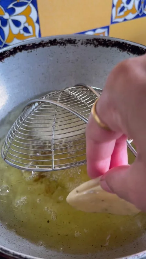 Putting the rolled dough mathri made of whole whet flour for deep frying in.. Vídeos de archivo 338373630