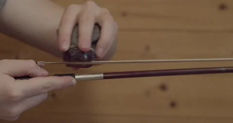 Putting rosin on violin bow Stock Footage 188683085