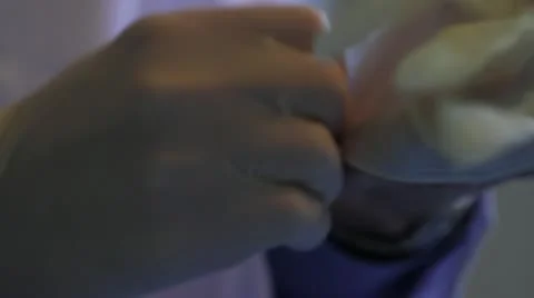 Putting on rubber glove and picking up syringe Stock Footage 20447433