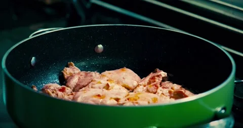 Putting salt in cooking chicken Stockbeeldmateriaal 167431848