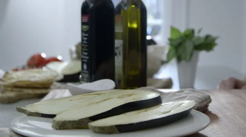 Putting salt on eggplant slices Stock Footage 63779552
