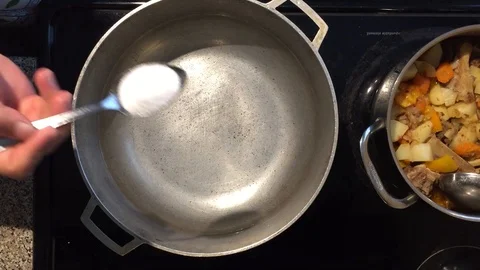 Putting salt into a pot Stock Footage 93462731