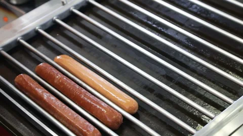 Putting sausages on the grill Video stock 85737776