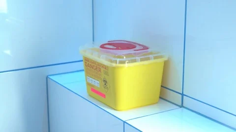 Putting a sharp biomedical waste into a special container Stock Footage 73397536