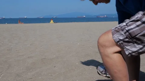 Putting shoes on at the beach. Видео 158290362