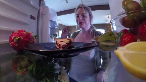 Putting a slice of leftover cherry pie in the fridge Stock Footage 78104201