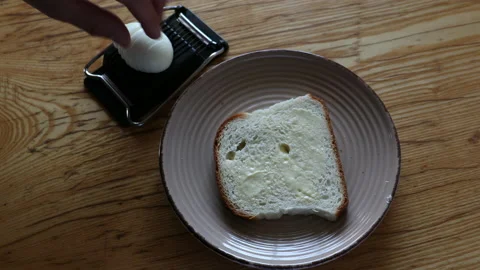 Putting sliced eggs on white bread Stock Footage 135800099