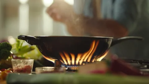 Putting sliced vegetables into the pan Stock Footage 311835250