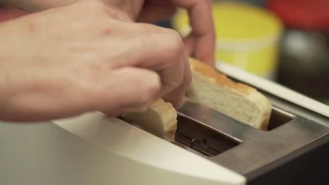 Putting slices of bread in the toaster Stock Footage 104004859