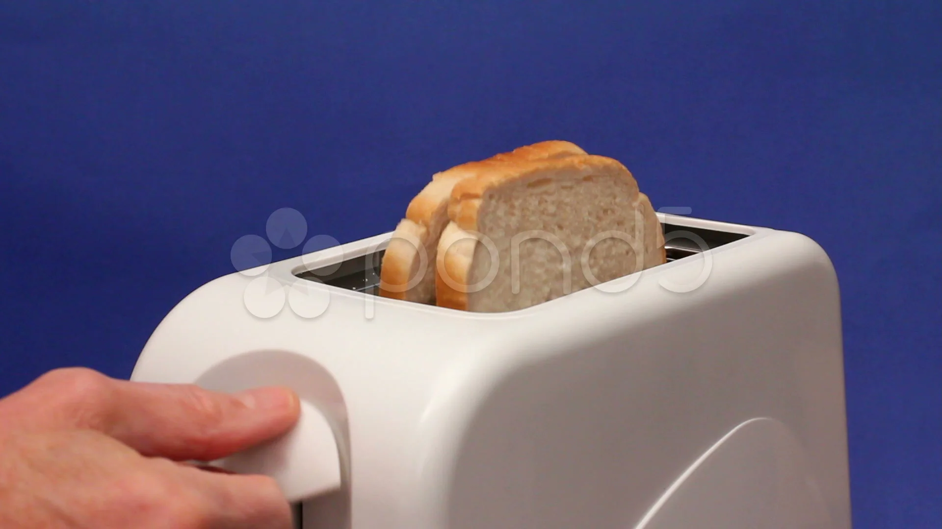 Putting slices of white bread into a toaster and switching on