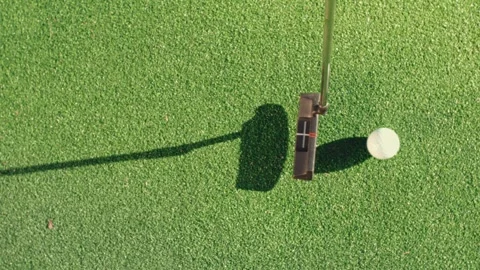 Putting Slow Motion Putter Ball Flagstick Backyard Green Overhead Hero Shot Top Video stock 334474145
