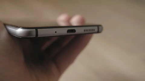 Putting smartphone to charging Stock Footage 88214116