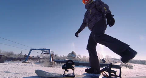 Putting on a snowboard boots. Stock Footage 131560577