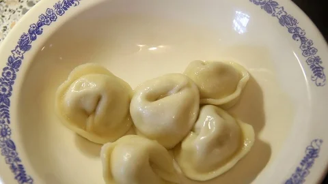 Putting some on a plate of cooked dumplings Stock-Footage 83033197