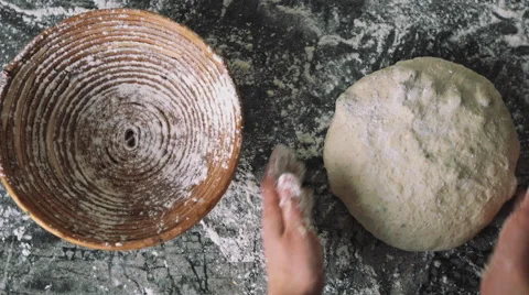 Putting the sourdough into the wooden rise basket Stock Footage
