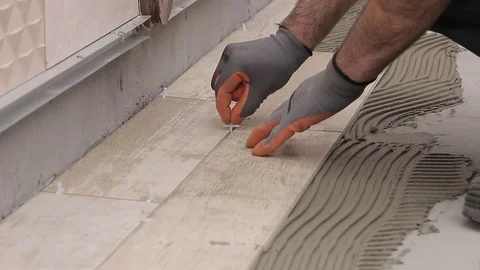 Putting spacers in ceramic tiles Stock Footage 111865316
