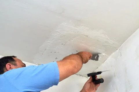 Putting spackle on a ceiling Stock Photos