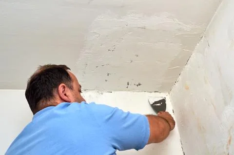 Putting spackle on a wall Stock Photos