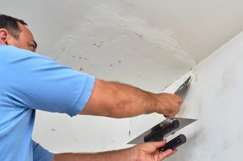 Putting spackle on a wall Stock Photos