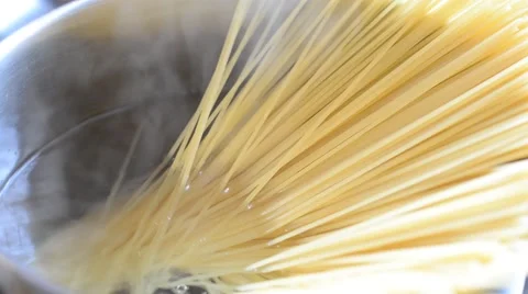 Putting spaghetti into the boiling water. Stock Footage 58891105