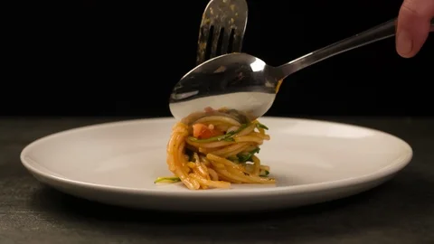 Putting Spaghetti on Fork on white Plate Stock Footage 104063530