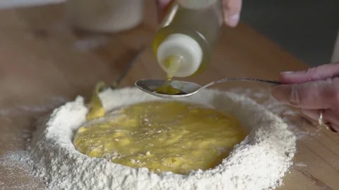 Putting a spoon of oil to make the dough,close up Stock Footage 74722247