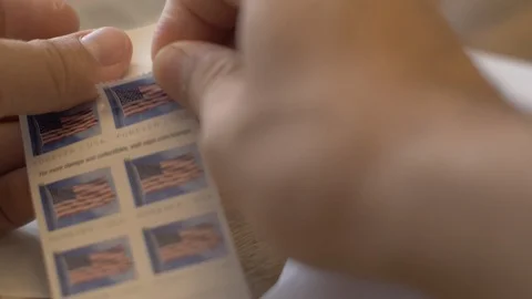 Putting Stamp on Envelope Stock Footage 116843572