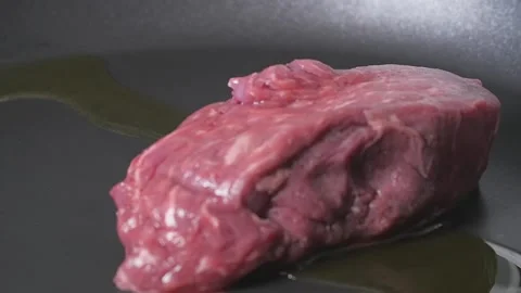 Putting Steak in Pan Slow Motion Stock Footage 169612457